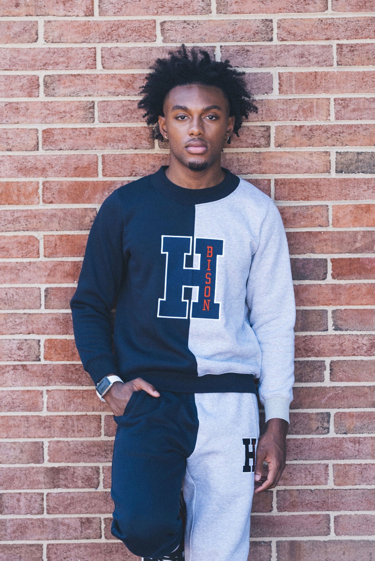This crewneck sweatshirt and sweatpants are half blue and half gray for the Howard University Bison. It is 50% cotton and polyester. The H logo is on the front of the sweatpants and a big H logo is blue with Bison n red on the front..