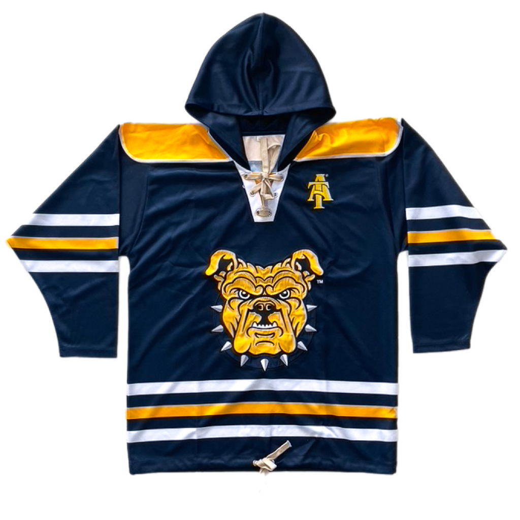 Blue, gold, and white hockey jersey with a hood for the North Carolina A&T State University Aggies. Material is 100% polyester. The front has the bulldog and A&T interlock logo.